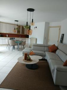 a living room with a couch and a table at A Beloeil, On Vous Acceuille in Beloeil