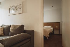 a living room with a couch and a bed at Apartments Obernosterer in Kaprun