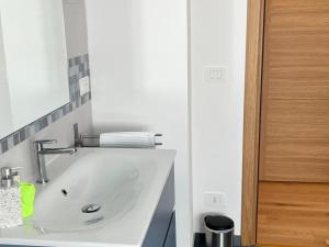 a white bathroom with a sink and a mirror at Quercia al Fiume in Ragogna +34 photos