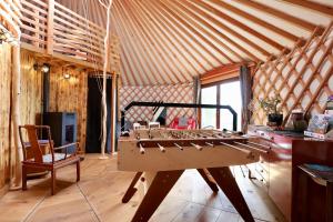 a room with a table in the middle of a room at Les Yourtes de La Valette in Floreffe