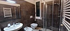 a bathroom with a sink and a toilet and a shower at Hotel Pensione Moderna in Bonassola +58 photos