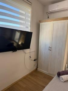 a room with a flat screen tv on a wall at Jorgovan in Bečići