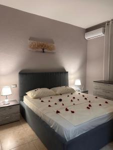 a bedroom with a bed with roses on it at S&E apartments in Tirana