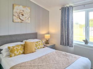 a bedroom with a bed and a window at Cherry Blossom 39 - Uk50708 in Garton
