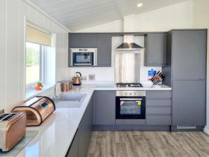 a kitchen with a sink and a stove top oven at Cherry Blossom 39 - Uk50708 in Garton