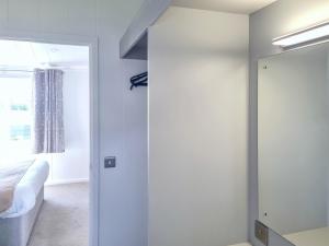 a bedroom with a mirror and a bed and a window at Cherry Blossom 39 - Uk50708 in Garton