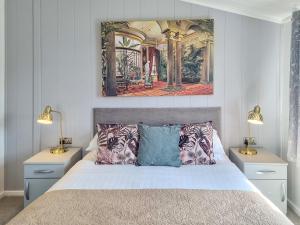 a bedroom with a bed with two night stands and two lamps at Cherry Blossom 39 - Uk50708 in Garton +2 photos