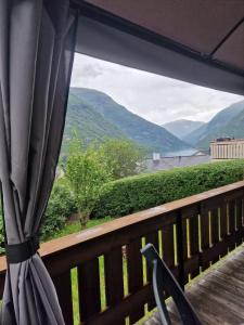a balcony with a view of the mountains at FjordNest Årdalstangen with sauna in Årdalstangen +16 photos
