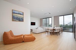 a living room with a couch and a dining room at Haus 42 in Bangkok