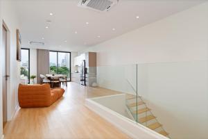 a living room with a glass staircase and a couch at Haus 42 in Bangkok +90 photos