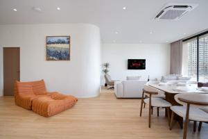 a living room with a table and a couch at Haus 42 in Bangkok