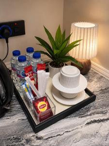a tray with plates and drinks on a table at Sukoon Al Jubail in Al Fanātīr +19 photos