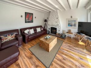 a living room with a couch and a fireplace at The Admirals in Sutton on Sea