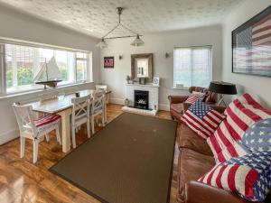 a living room with a couch and a table at The Admirals in Sutton on Sea