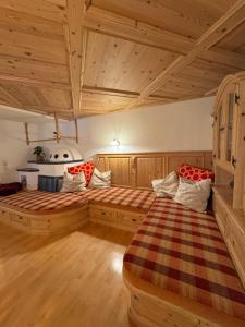a bedroom with two beds in a room with wooden ceilings at Haus Krone in Lähn