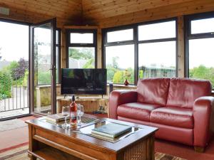 a living room with a couch and a coffee table at Sauchenshaw Cottage in Maryculter
