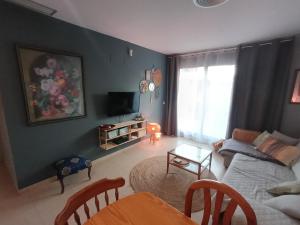 a living room with a couch and a table at Apartment with terrace in Vinarós