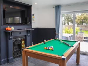 a living room with a pool table and a tv at The White Anchor in Newborough