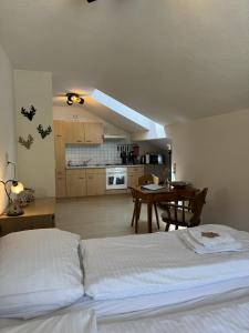 a bedroom with a bed and a kitchen with a table at Haus Krone in Lähn