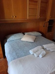 a bed with two rolled up towels on it at Casa JEANMARC in Moneglia