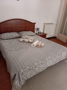 a bedroom with a bed with two slippers on it at Casa JEANMARC in Moneglia