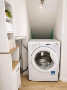 a washer and dryer in a small room at Family nest Medulin- apartment with private parking and jacuzzi in Medulin