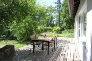 a wooden table and chairs on a patio at Erholung im Grünen in Weissach