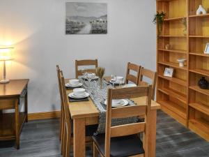 a dining room with a wooden table and chairs at New House Farm - Ukc6912 in Leck