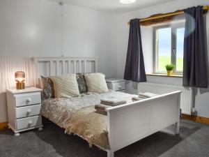 a bedroom with a white bed and a window at New House Farm - Ukc6912 in Leck
