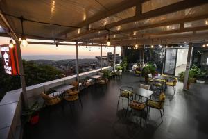 a restaurant with tables and chairs on top of a building at Backpacker Hostel Kruje in Krujë