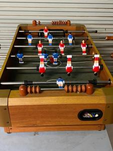 a wooden pool table with balls and dolls on it at Goolwa Retreat in Goolwa North