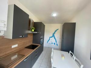 a kitchen with a white table and a blue painting on the wall at Como Lake Grigna in Bellagio +22 photos