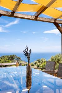 a glass table with a view of the ocean at Nous Village 2 in Alyki