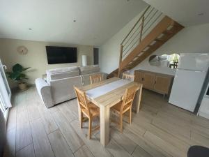 a living room with a table and a couch at Sable d or wissant in Wissant +5 photos