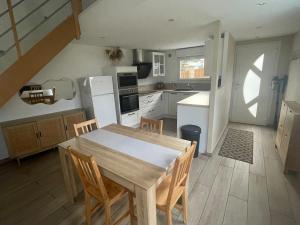 a kitchen with a table and chairs in a room at Sable d or wissant in Wissant