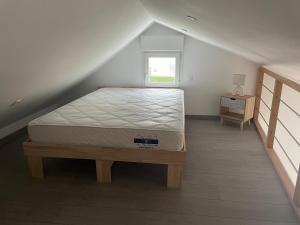 a bedroom with a bed in a attic at Sable d or wissant in Wissant