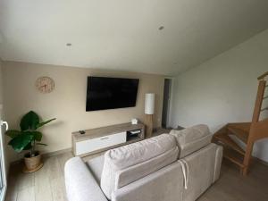 a living room with a couch and a flat screen tv at Sable d or wissant in Wissant