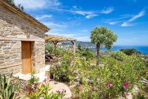 a stone house with a view of the ocean at Nous Village 2 in Alyki