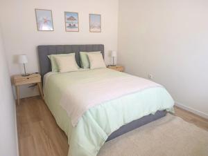 a bedroom with a large bed with two night stands at Casa Serra & Mar in Azeitao