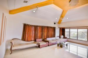 a living room with two couches and a couch at Cloud 9 Hills Resort in Lonavala