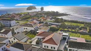 an aerial view of a small town next to the ocean at Casa MiRaMar in Mosteiros