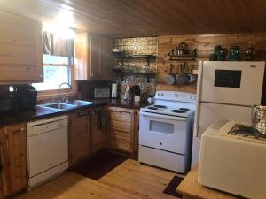 a kitchen with a white stove and a white refrigerator at Ducks Nest Retreat- Close to Ocoee river in Turtletown