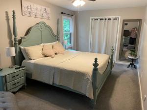 a bedroom with a large bed and a mirror at Golf, Hot tub, Arcade, Poker Table, Wildlife, Internet, Pet Friendly, Name-May the Course Be With You in Ellijay