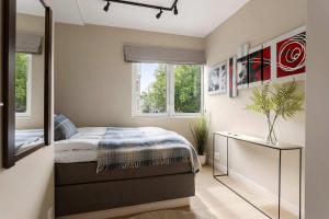 a bedroom with a bed and a large mirror at 5BR 2Bath Frogner - Parking - Vigelandsparken in Oslo