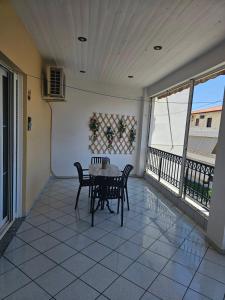 a patio with a table and chairs on a balcony at Astros by the sea in Paralio Astros