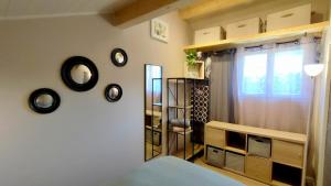 a bedroom with a bed and a window and a shelf at Logement indépendant dans villa direct plage Lac Leman Evian in Publier