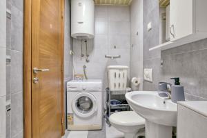 a small bathroom with a washing machine and a sink at Apartments Moskov in Kotor +150 photos