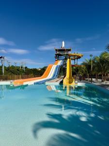 a water slide in a park with a pool at Spazzio diRoma Caldas Novas in Caldas Novas