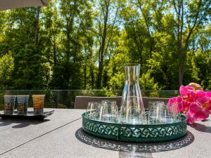 a table with a glass vase and flowers on it at Contemporary villa between Paris and Disneyland in Champs-sur-Marne