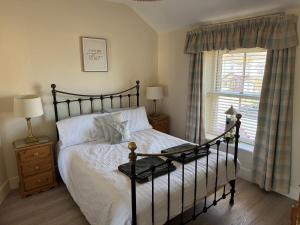 a bedroom with a large bed and a window at The Hideaway in Llandudno